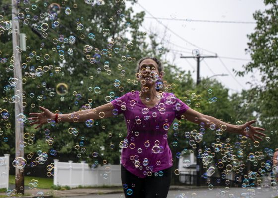 November Project Boston Member running through the soap bubbles