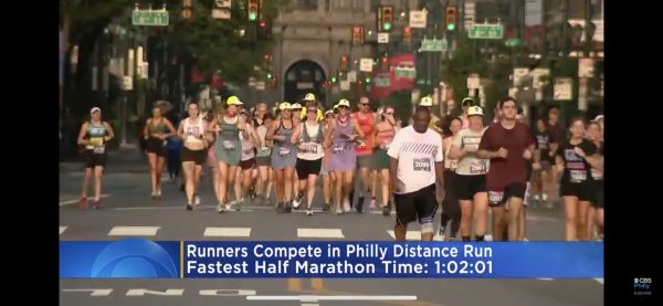 A screen shot of a local news segment featuring Rashel and other NPDC runners in exercise dresses at the Philly Distance Race.