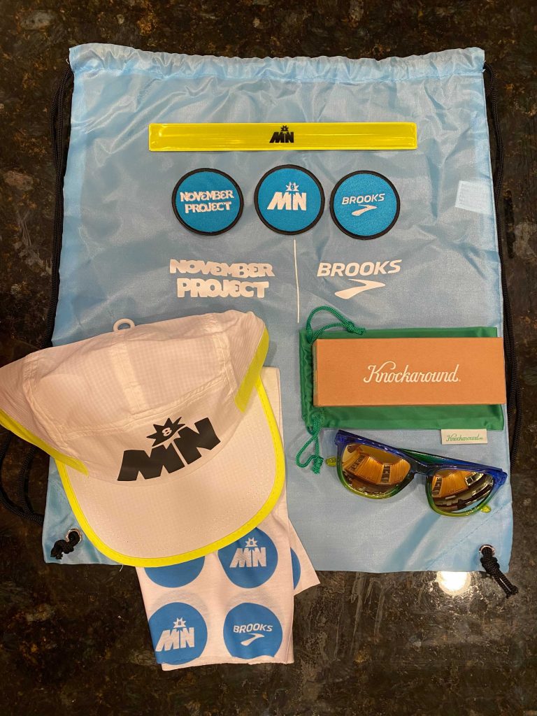 Photo of cinch bag with Brooks and November Project branded items