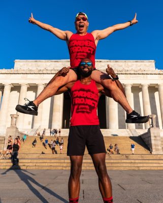 Young on Jolly's shoulders posing in front of the Lincoln Memorial in DC