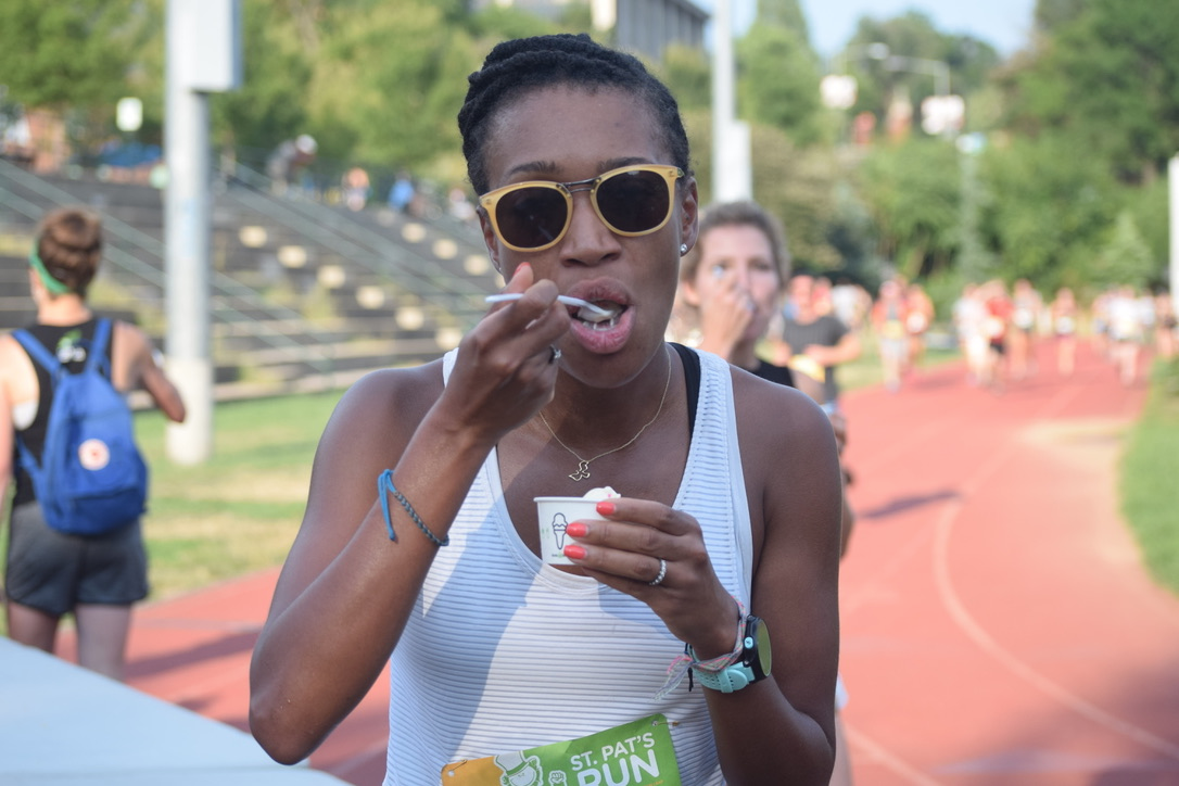 A young woman eats from a Shake Shack cup during the 2019 Custard Chase race